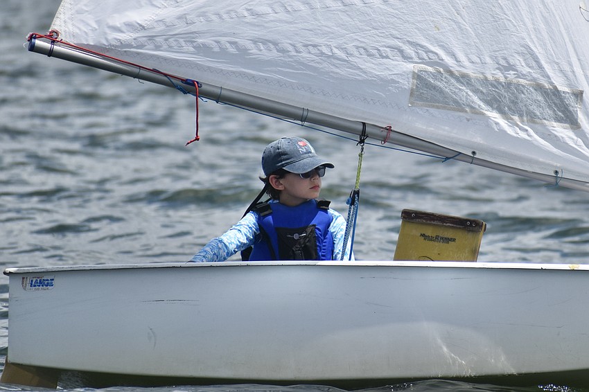 Eliott Kamenev of the Optimist Green fleet of the Sarasota Sailing Squadron keeps an eye on the waters ahead.