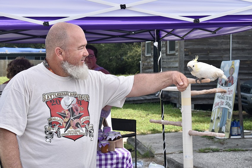 Myakka City resident Curtis Myers meets a Sulphur crested cockatoo that took a little nip at his finger a minute later.