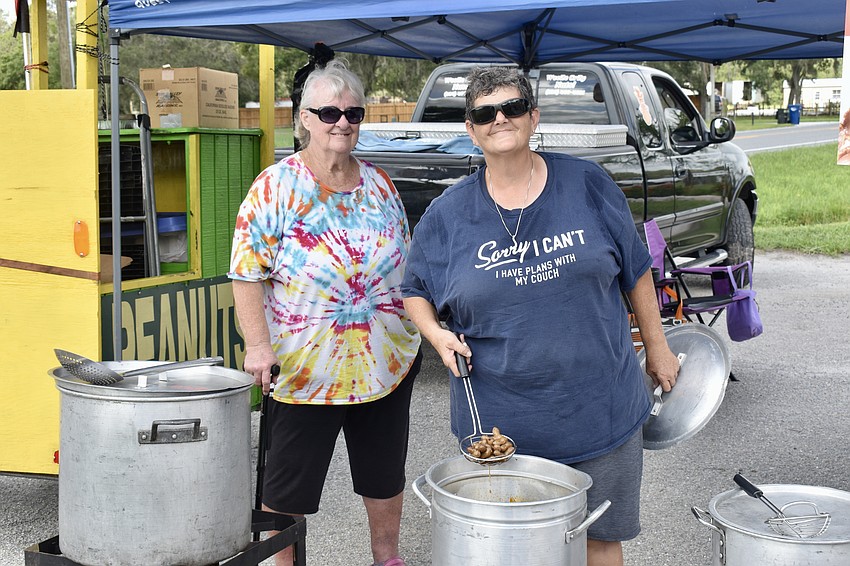 Kay Ross and Carol Drawdy share a tent. Ross sells cookies, and Drawdy sells boiled peanuts.