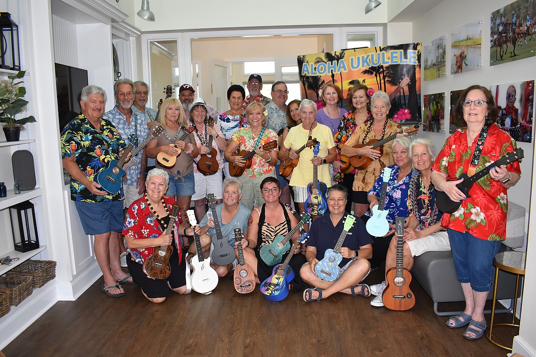 The Aloha Ukulele club of Lakewood Ranch donates eight ukuleles to the new Lakewood Ranch Library, represented by Tiffany Mautino (first row, center).