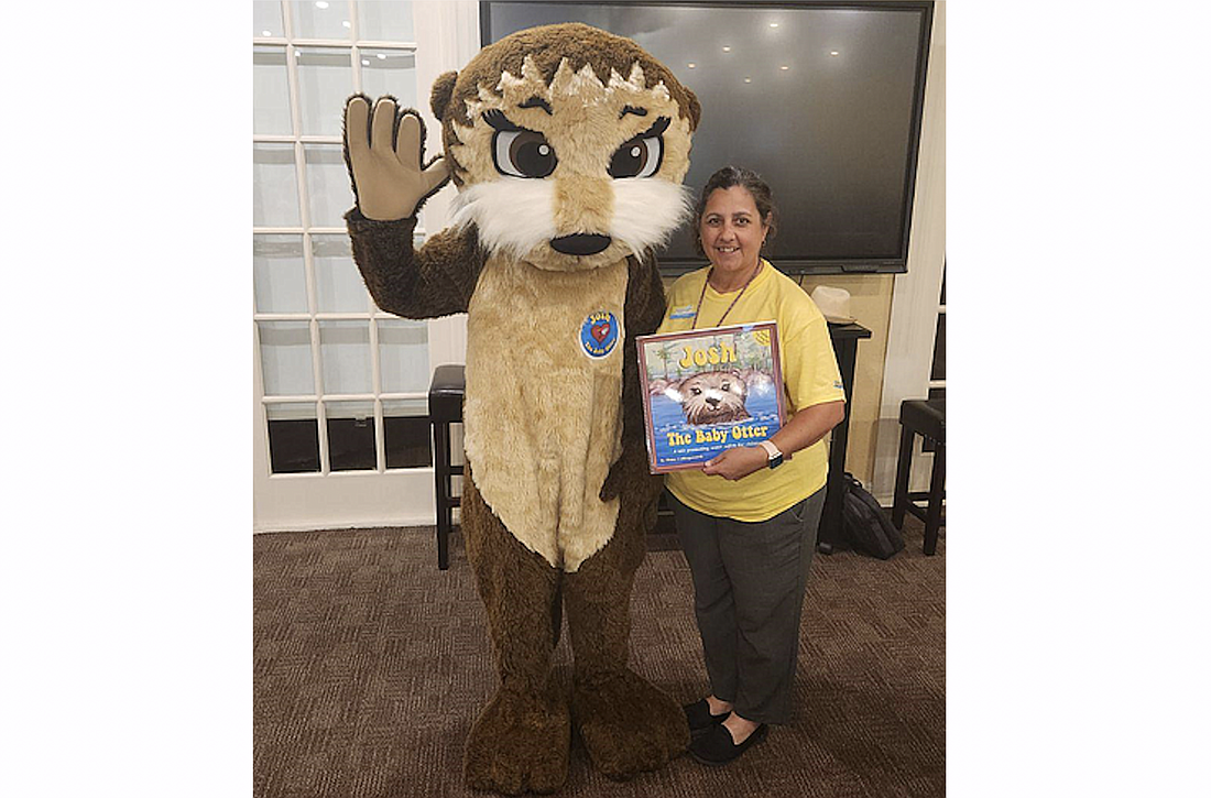 ELCFV's Literacy Initiatives Coordinator Erica Garris poses with Josh the Otter. Courtesy photo