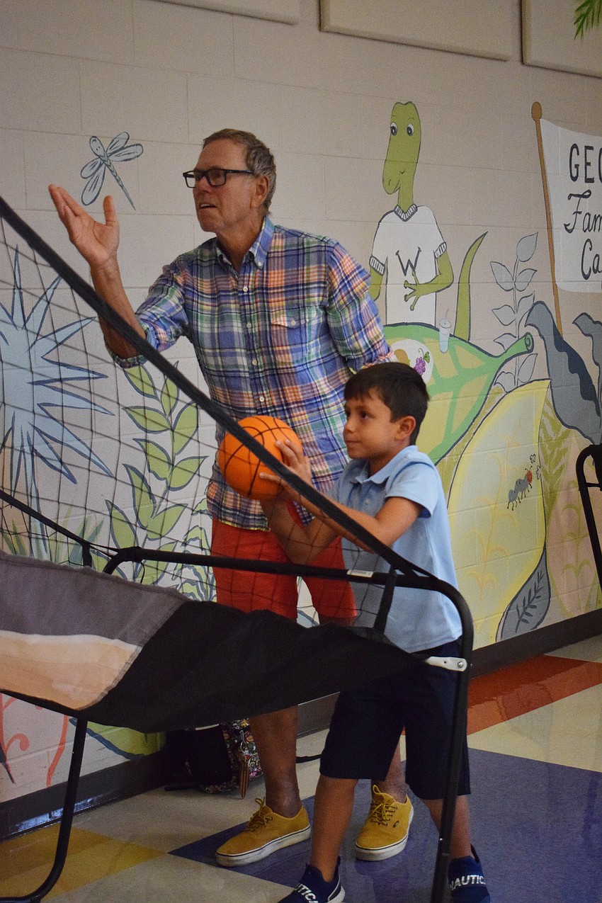 Jeff Gundersen plays basketball with his grandson Rafael Sastoque during Robert E. Willis Elementary School's first Games with Grandparents night.