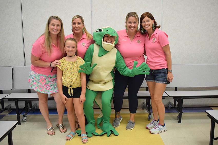 Parent-Teacher Organization President Allie Freund, third grader Peyton Hill, PTO secretary Mindy Buckley, Missy Wienandy dressed as the school's mascot, PTO vice president Jess Tripoli and treasurer Colleen Laughlin are thrilled to see so many grandparents in attendance.
