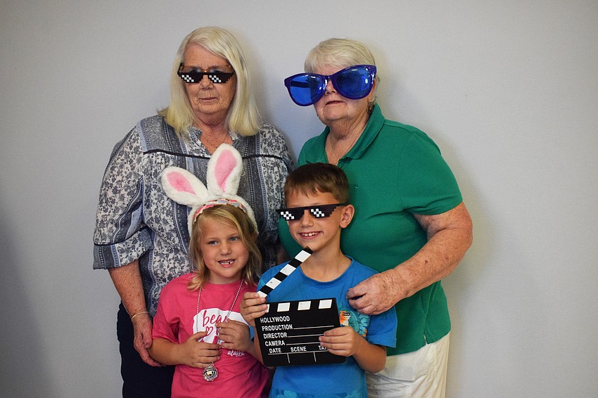 Laura Griffin and Patricia Jacobsen make a memory with kindergartner Grace Martin and second grader John Martin.