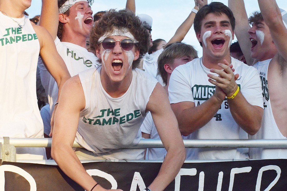 Lakewood Ranch High School seniors Ryan Donnelly and Lucas Anthony cheer their loudest as the football team gains a first down.