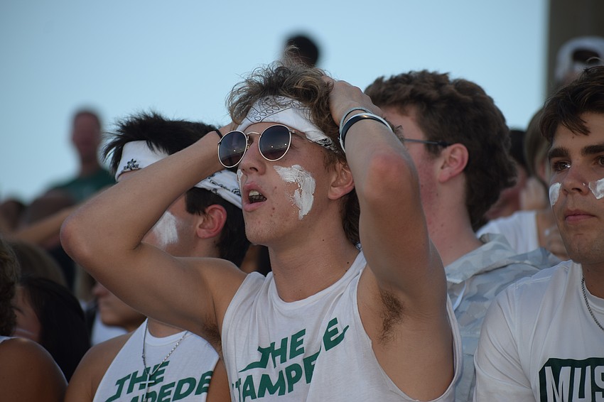 Ryan Donnelly, a senior and the designated hype man for Lakewood Ranch High School's Stampede, reacts to Braden River High School getting a first down. The next moment he was screaming as loud as he can to cheer for his team.