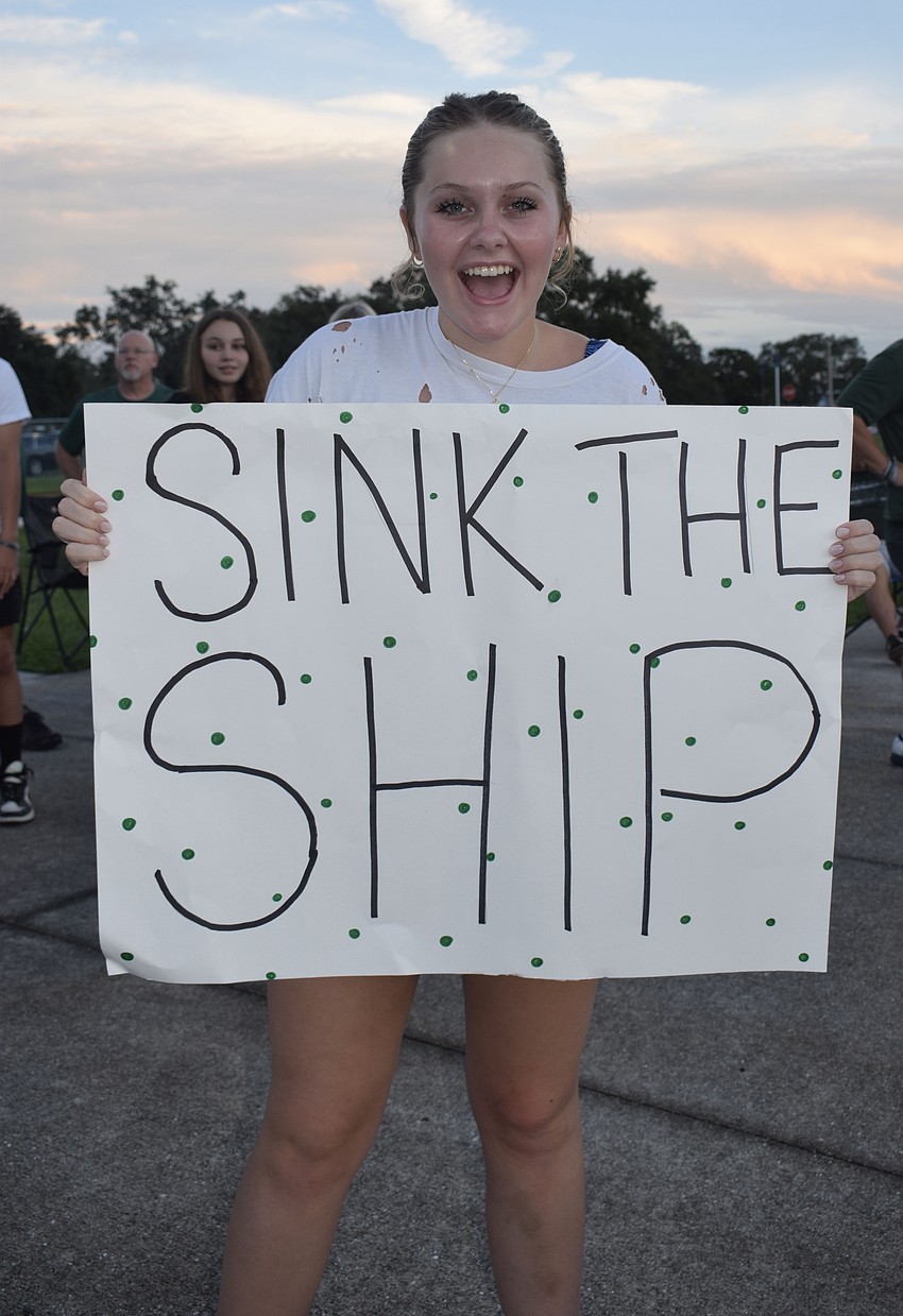Lakewood Ranch High School senior Emaline Chope shows off her poster targeted at Braden River High School, whose mascot is a pirate.