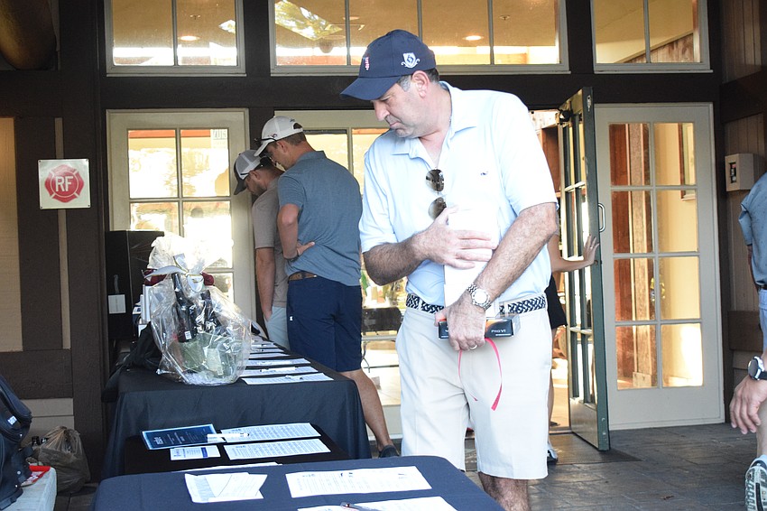 Lakewood Ranch's Rob Valorie looks to see what's available in the silent auction.