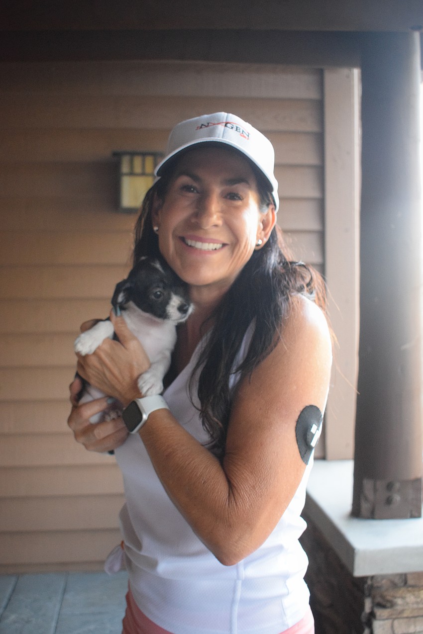 Lakewood Ranch's Lisa Upman is happy to receive puppy kisses from a Nate's Honor Animal Rescue puppy.