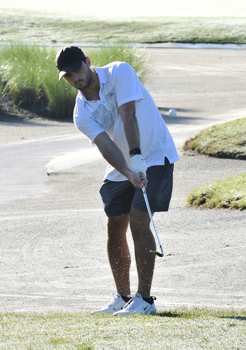 Sarasota's Parker MacPhail chips his ball toward the hole.
