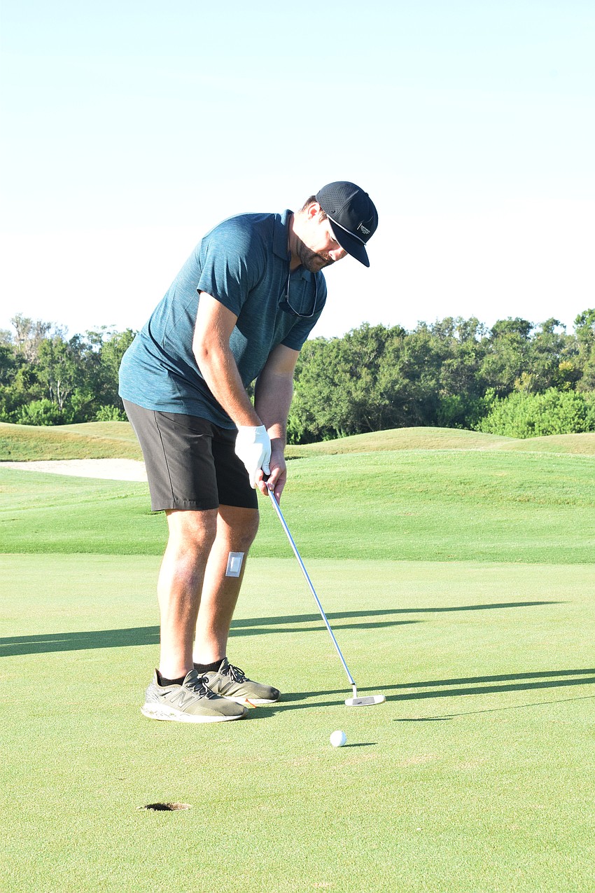 Sarasota's Zach Davis watches as his ball makes its way to the hole. It just missed.