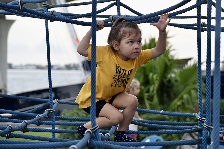 Four-year-old Valiana Moore climbs the jungle gym.
