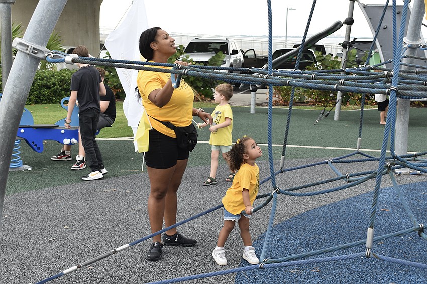 Alaysha Prestia and 2-year-old Eleasia Prestia take a look at the jungle gym at Hart's Landing.