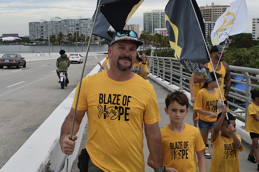 Chris Harmon and 10-year-old Logan Harmon take the walk.