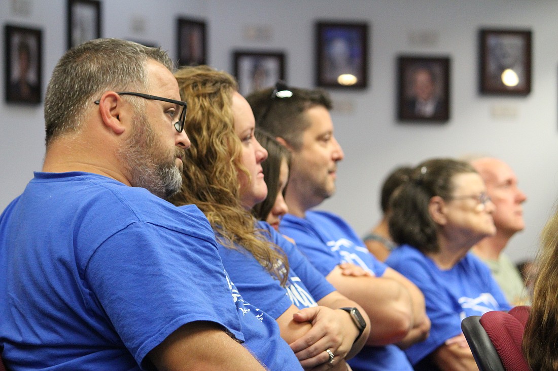 Reverend Randall LaRoche and his wife Heidi attend a planning commission meeting on Aug. 10 with about 25 other Elwood Park residents. Heidi LaRoche came up with the idea for everyone to wear matching Elwood Park T-shirts when attending commission meetings. She makes the T-shirts, too.
