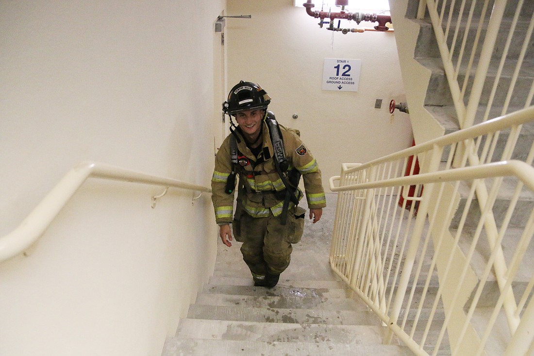 Ormond Beach Firefighter Zander Harper climbs flights of stairs in memory of 9/11 at Marina Grande on the Halifax. Photo by Jarleene Almenas