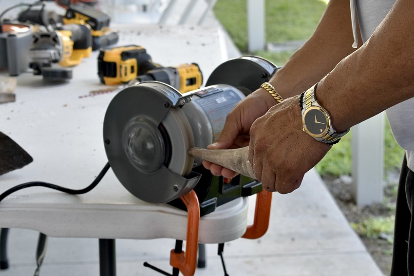 Facilities manager Jorge Ceballos removes the tip of a horn.