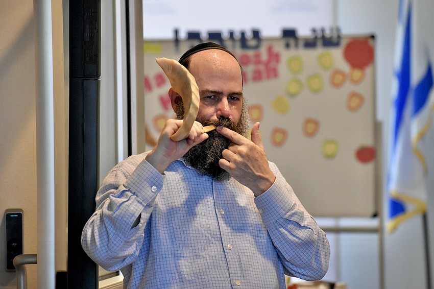 Rabbi Chaim Steinmetz demonstrates shofar blowing.