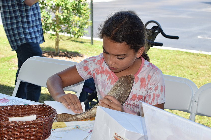 9-year-old Maya Moronta sands her horn.