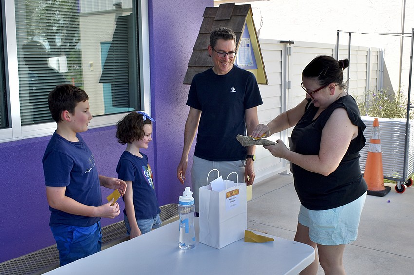 Ari Sinanian, 10, Mia Sinanian, 7, Craig Sinanian and Emily Kaufman make a shofar together as a family.