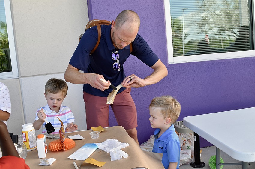 Judah Smith, 5, Gerrid Smith, and Ezra Smith, 3, work on the shofars together.
