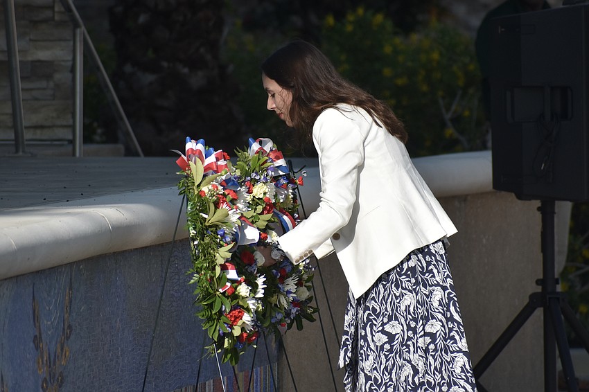 USF Veteran Support Coordinator Savannah Rains places a wreath.