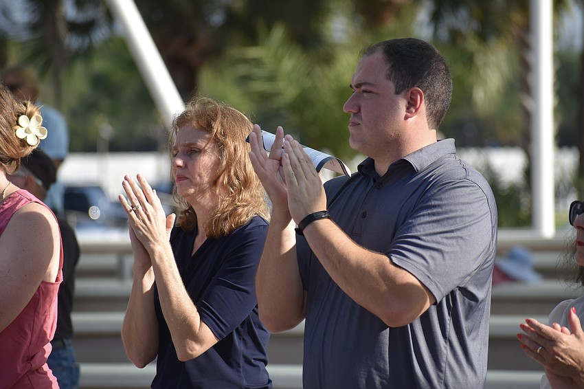 Pamela D'Agostino and Gil Bullock applaud the ceremony.