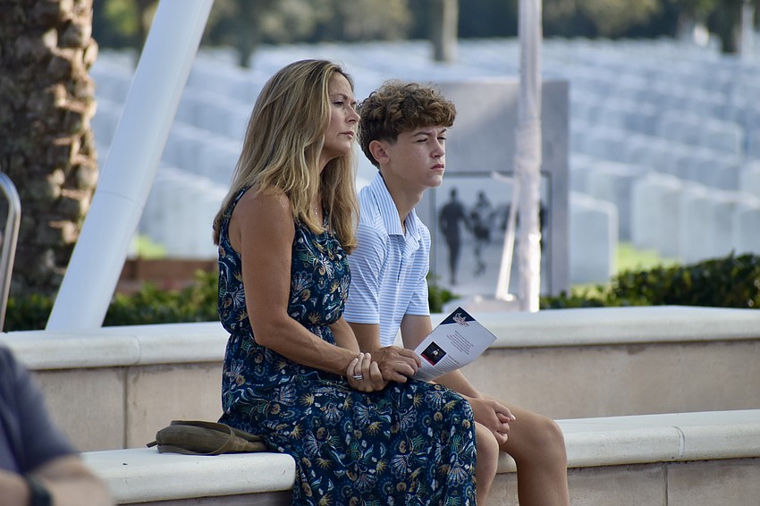 Andria Konstantopoulos and 12-year-old Michael Konstantopoulos watch the ceremony.