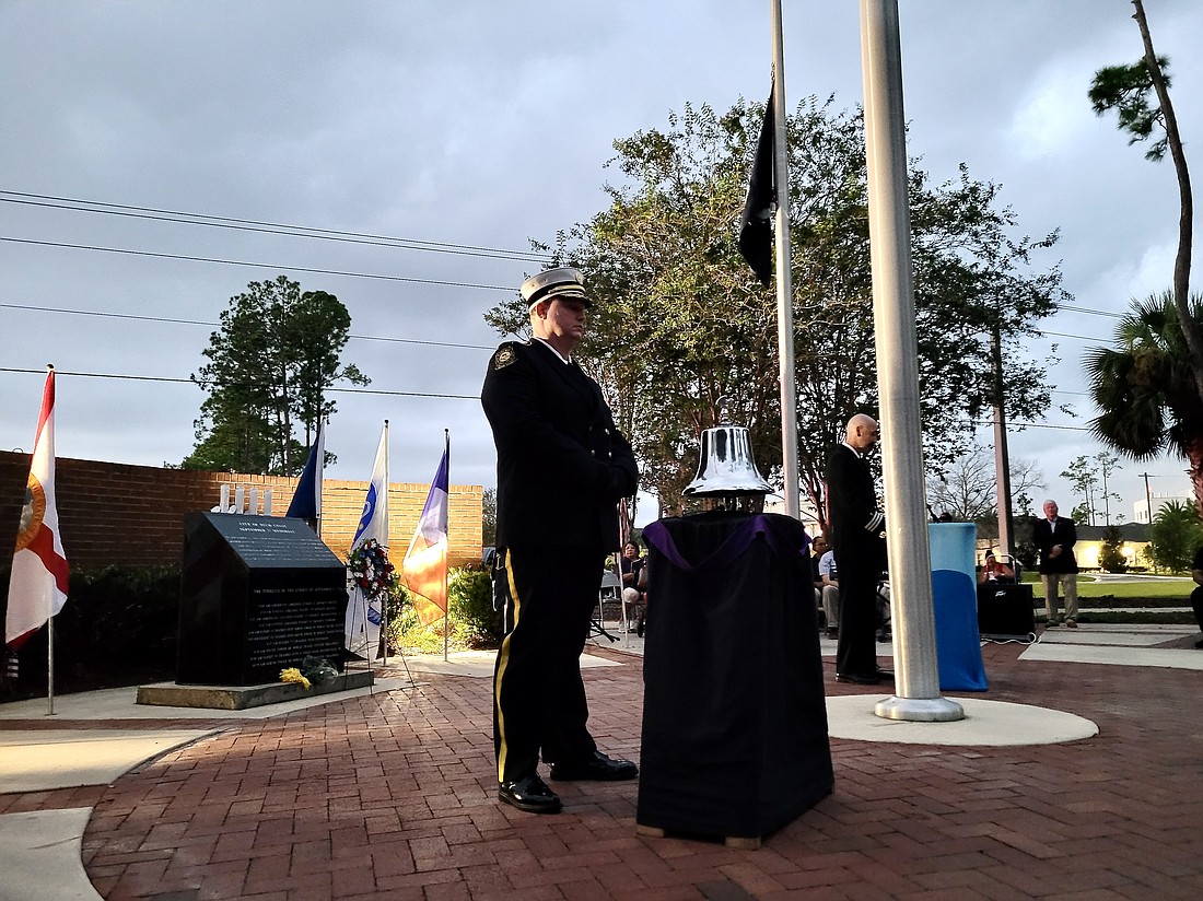 A PCFD Honor Guard member prepares to ring the Firefighter Memorial Bell. Photo by Sierra Williams