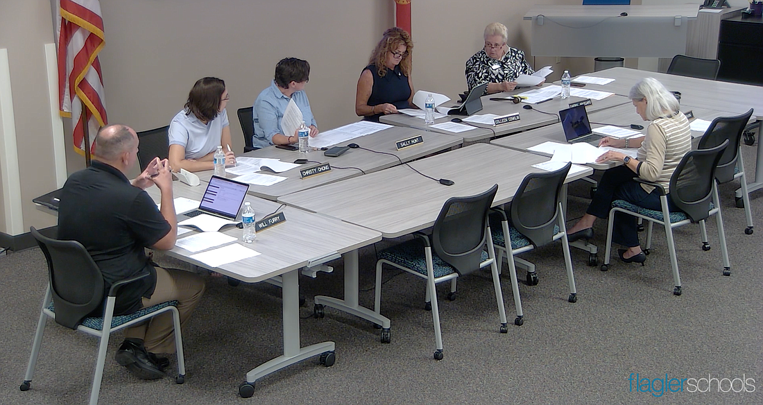 Board members Will Furry, Christy Chong, Sally Hunt, Colleen Conklin and Cheryl Massaro go over the superintendent's contract with Board Attoney Kristy Gavin. From Flagler Schools video