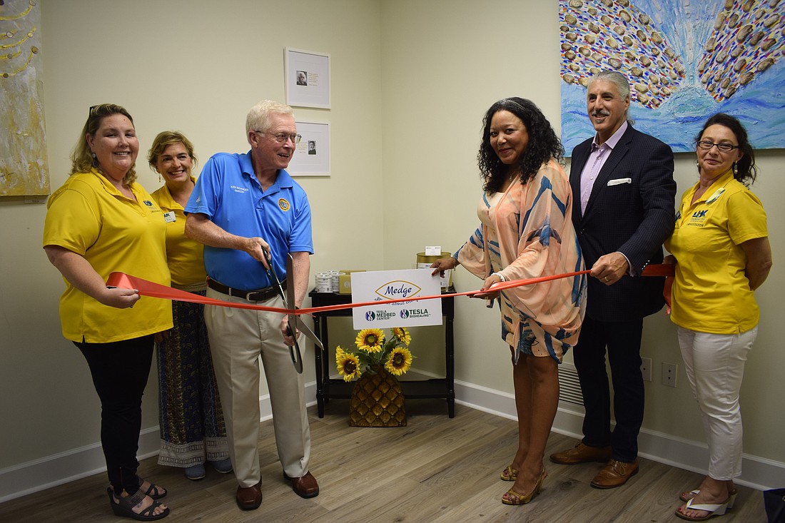 The ribbon cutting of the Holistic Healing and Wellness Center of Longboat Key with Deanna Mesghali, Patti Bosco, Mayor Ken Schneier, Medge Jaspan, Michael Jaspan and Irina Bronstein.