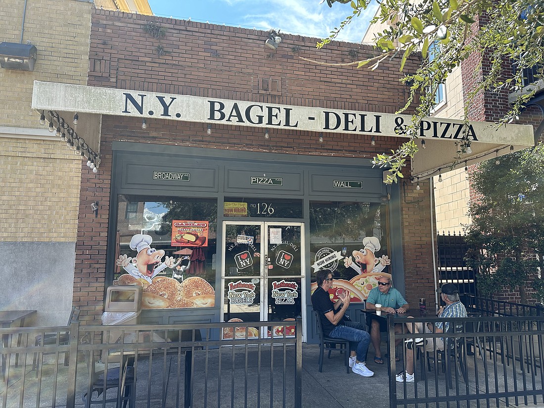 A sign on NY Bagel Deli & Pizza's door reads "permanently closed."