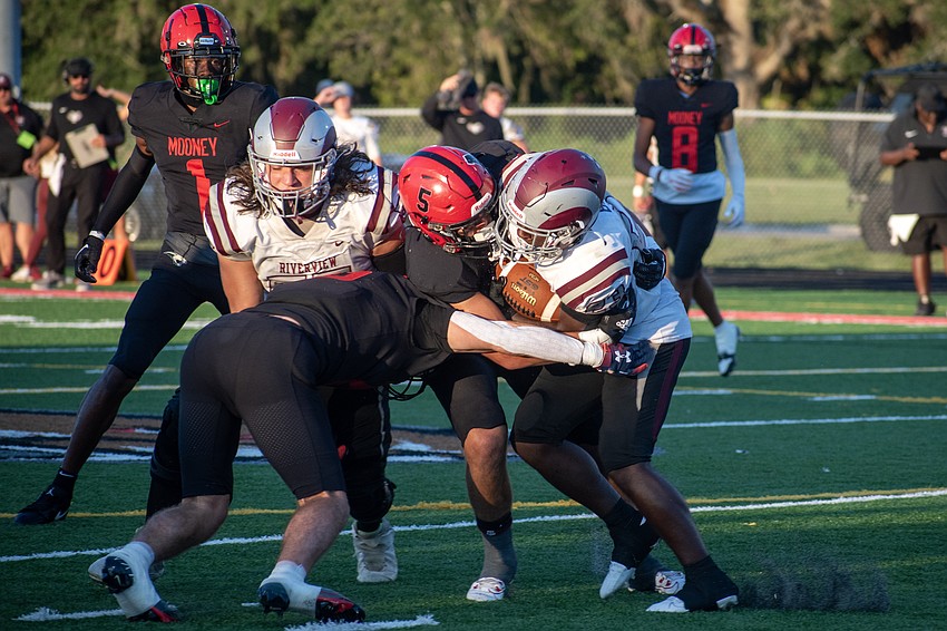 Cardinal Mooney senior George Leibold (5) hits Riverview sophomore Isaiah Belt with a tackle.