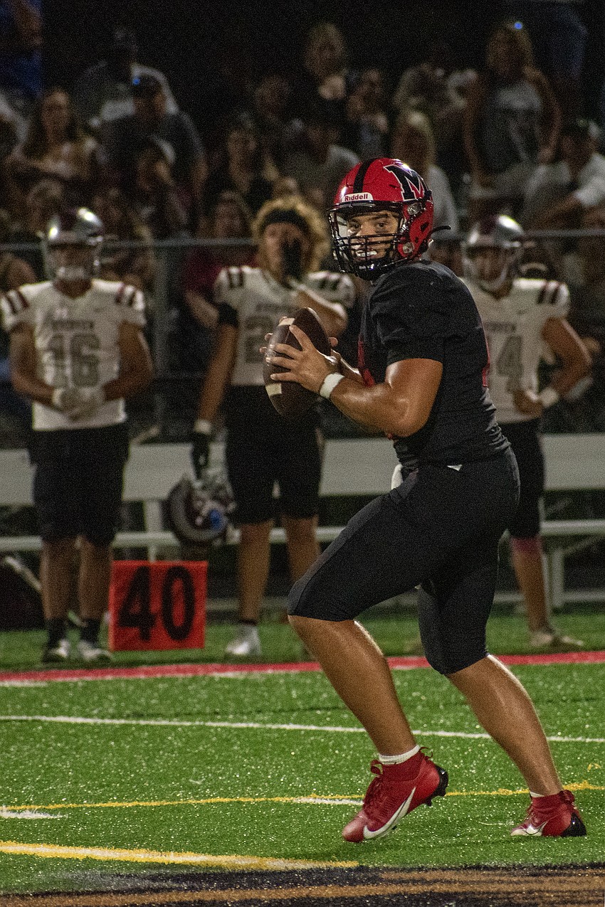 Cardinal Mooney sophomore quarterback Devin Mignery looks for an open receiver. Mignery played the second half for the Cougars.