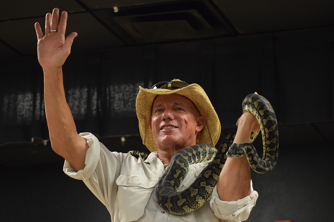 John Kenyon, or "Gator John," who is an educational outreach programmer, tries to calm students as they scream over the carpet python he's holding.