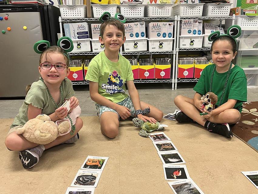 First graders Elyssa Riggs, Tyler Shomo and Brixtyn Murphy separate the animals that live in the Everglades from those that don't.
