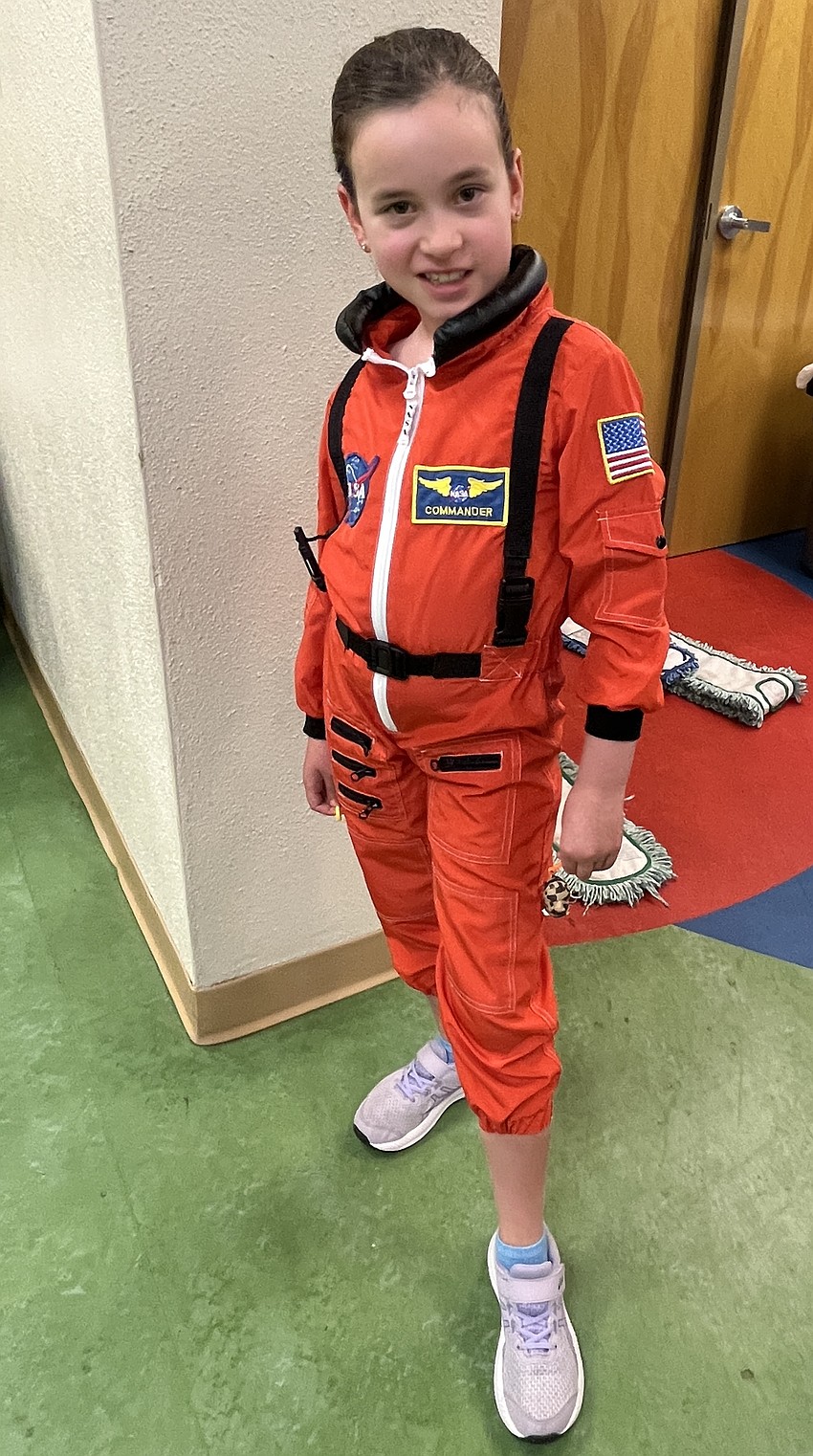 Penelope Riggs, a third grader, shows off her astronaut costume.