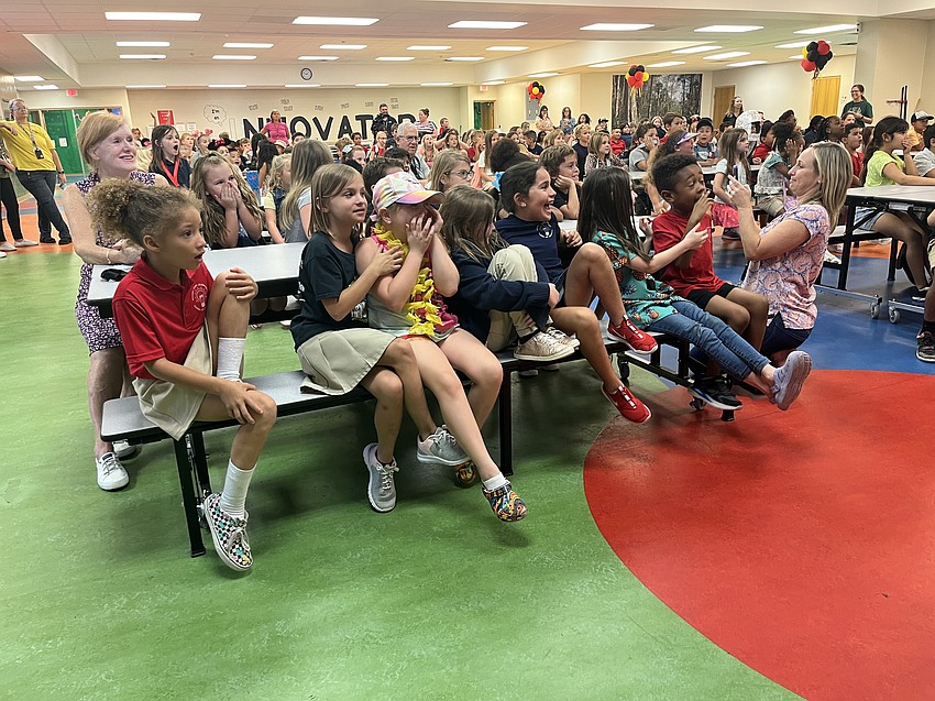 Students react to seeing a carpet python and alligator.