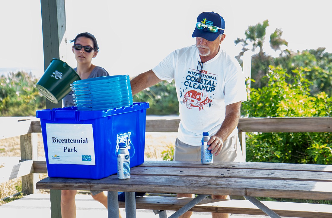 Lindsey Kauffman and her father, Scott Wasdin of Ormond Beach, organize supplies for International Coastal Cleanup on Saturday, Sept. 16 at Michael Crotty Bicentennial Park in Ormond-by-the-Sea. Photo by Suzanne McCarthy