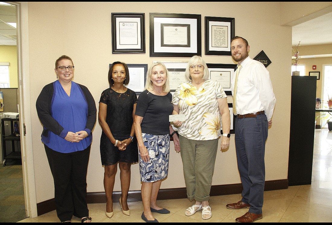 April Hudson, Tonya Wright, Nancy Bradley, Aleta Dick — who presented the check on behalf of Peninsula Women's Club — and Bill Bradley, vice president of Daytona College. Courtesy photo