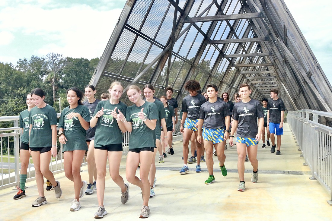 The Flagler Palm Coast High School track and field teams ran across the new pedestrian bridge and back to celebrate its grand opening. Photo by Sierra Williams