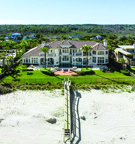 Oceanfront Mediterranean-style two-story home features, six bedrooms, seven full and two half-bathrooms, office, game room, elevator, butler’s pantry, outdoor entertainment area, porches, balcony, summer kitchen, pool and dune walkover.