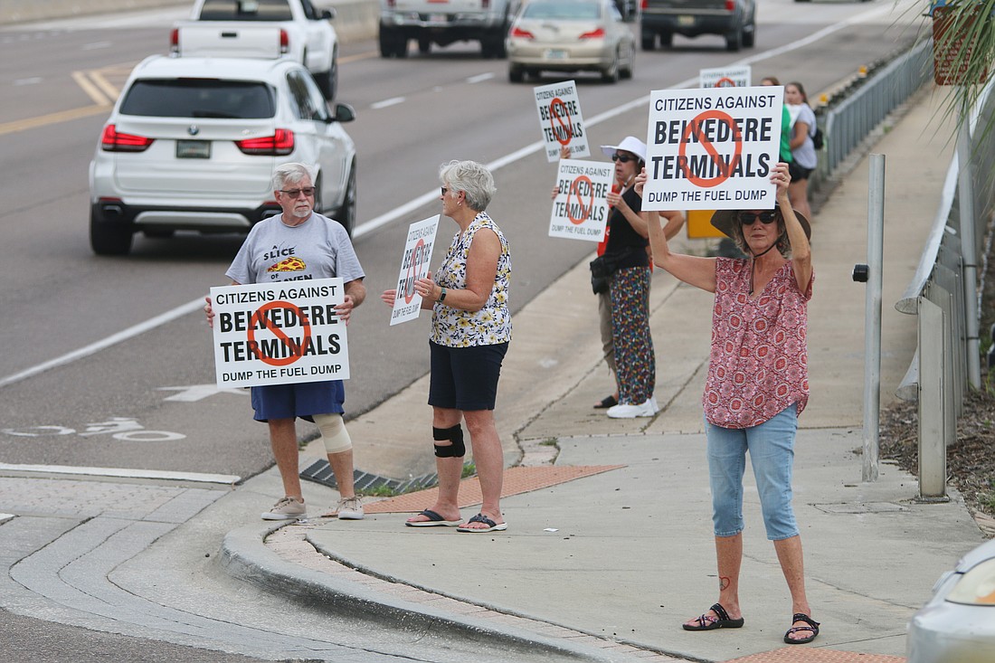 Kathleen Lowery holds up a sign against Belvedere Terminals at the base of the Granada Bridge on Wednesday, Sept. 20. Photo by Jarleene Almenas