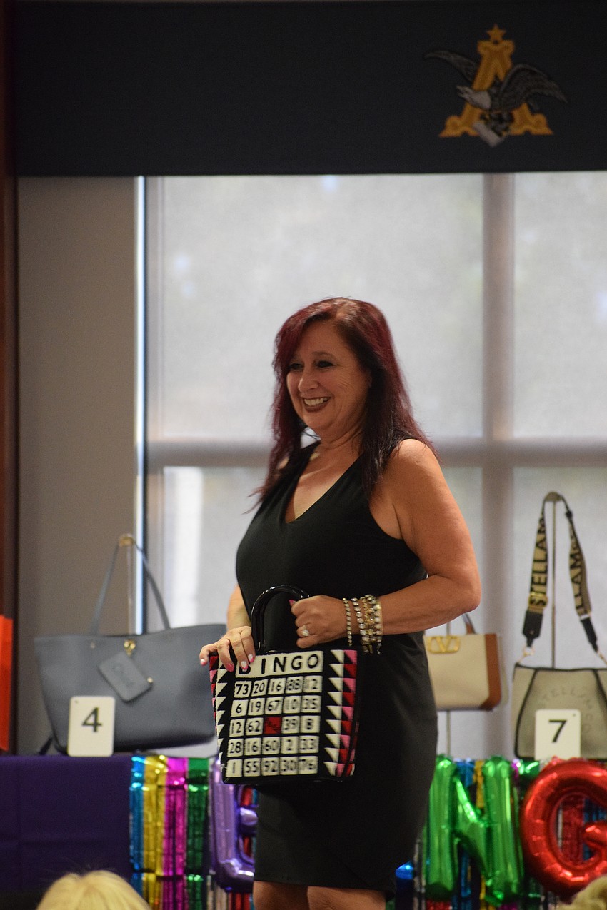 Darci Jacobs, the owner of Darci Boutique, dazzles Designer Bag Bingo participants.