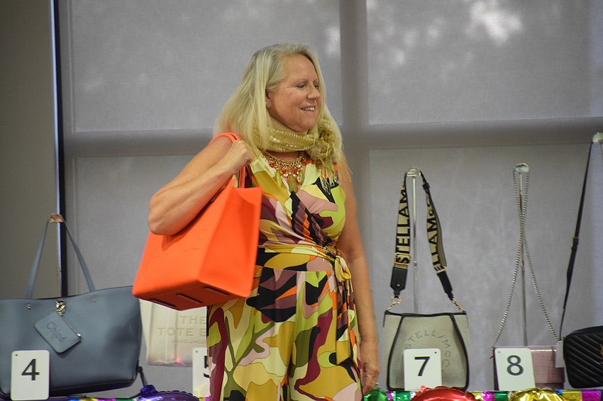 Sarasota's Becca Towery models a Versace bag and clothing from Darci Boutique.