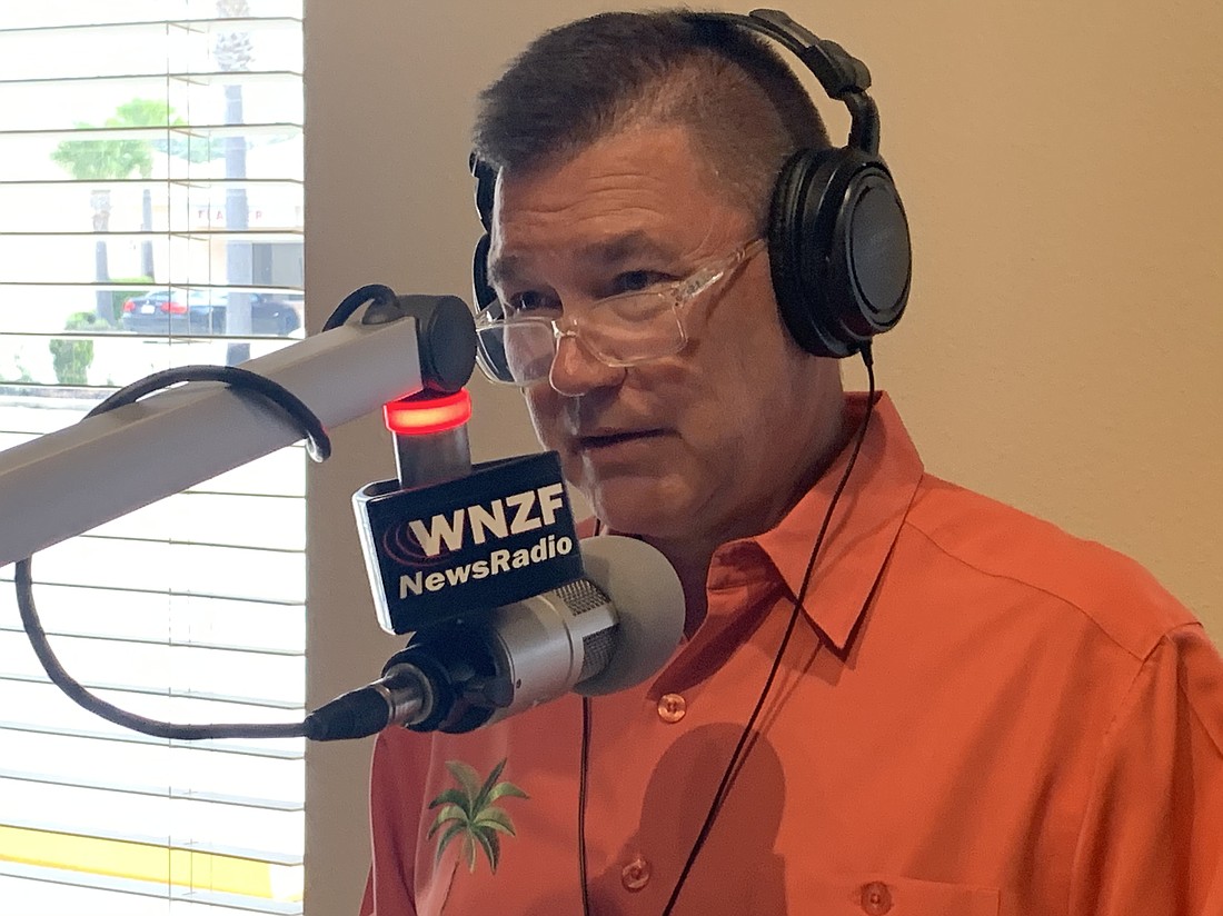 Kirk Keller on the air with Flagler Broadcasting's WNZF News Radio. Photo courtesy of Flagler Broadcasting