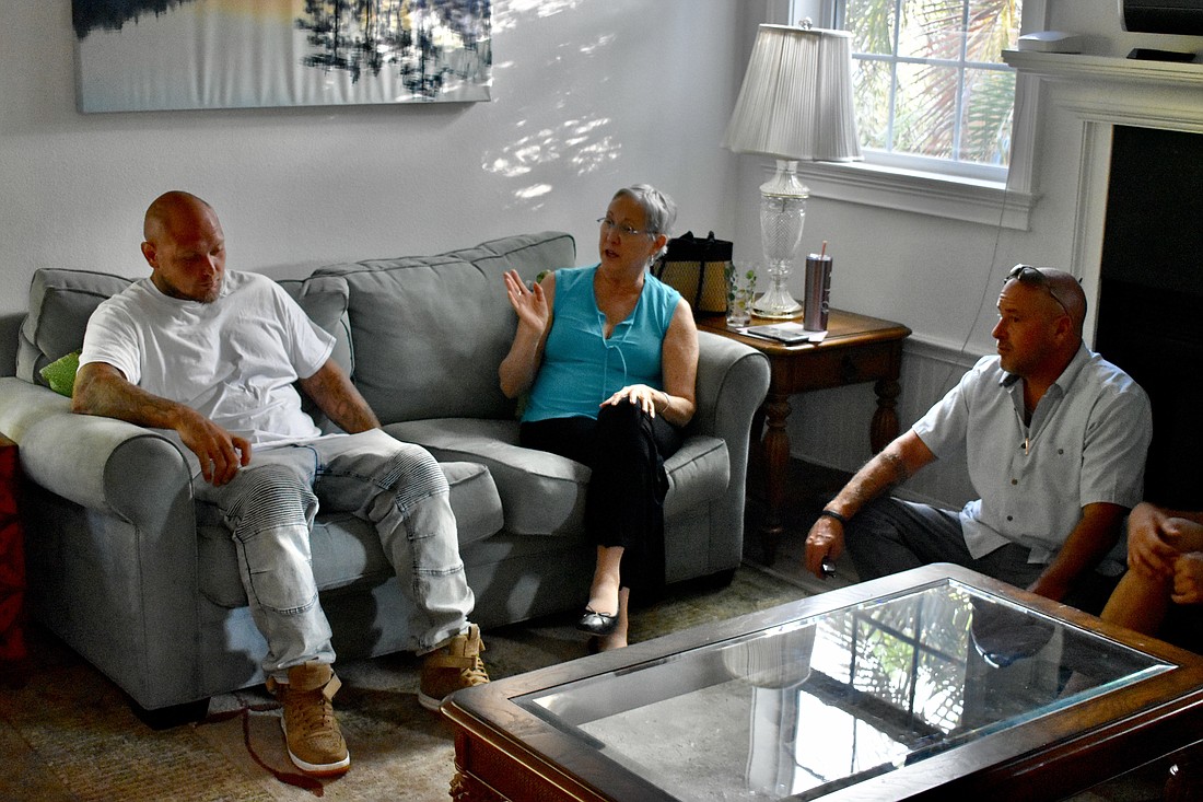Mark Stackhouse, Barbara Richards Thomas Graff talk during a meeting.