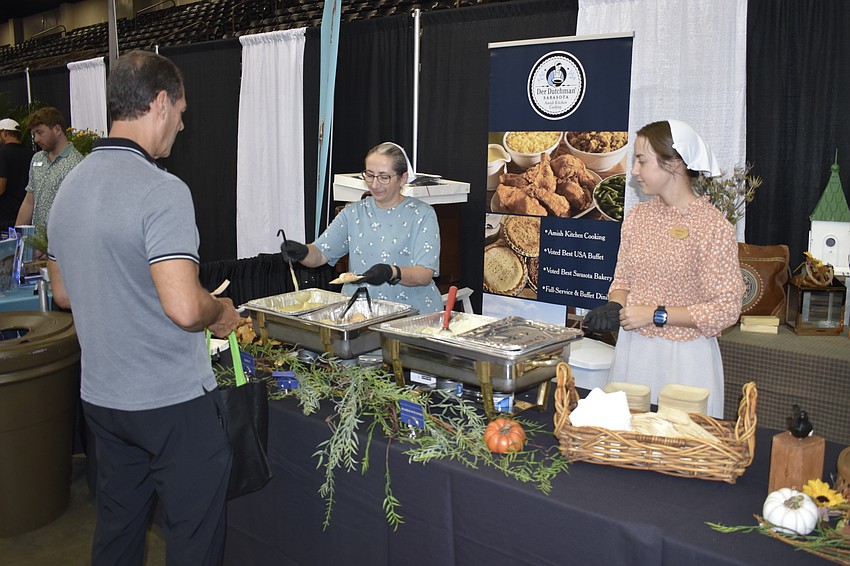 Sarasota's Patrick O'Dell samples some offerings from Der Dutchman whose table is staffed by Sarasota's Mary and Mariah Miller.