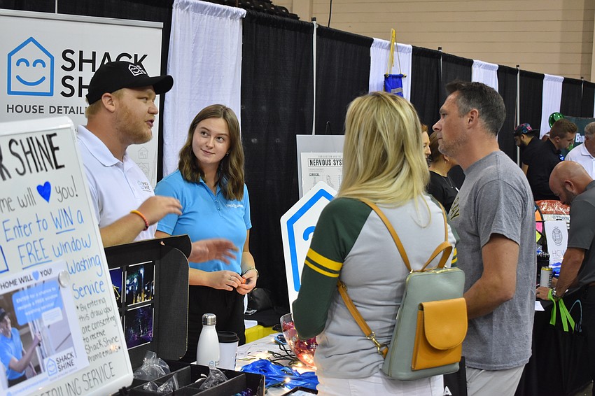 Lakewoo Ranch's Matt and Mackenzie Schafer of Shack Shine speak with Lakewood Ranch's Mark and Amanda Dalnodar.