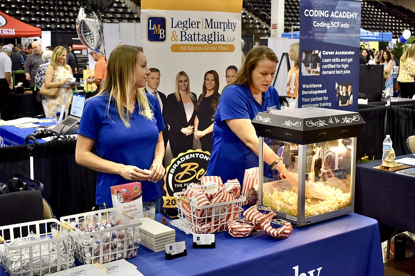 Lakewood Ranch's Kelli Martinez and Alyson Battaglia serve popcorn with Legler, Murphy & Battaglia.